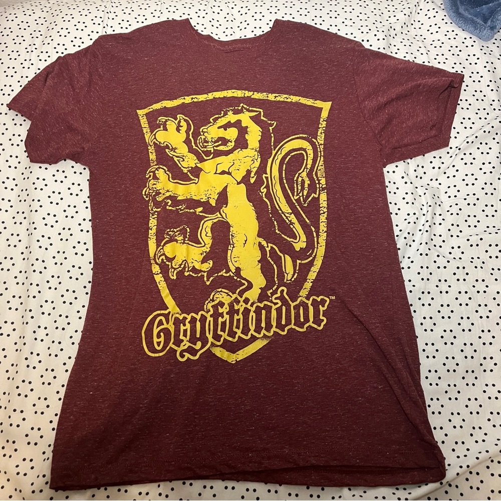 Maroon t shirt with Harry Potter Gryffindor House symbol.